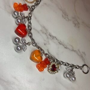 Elegant Silver Charm Bracelet with Red and Orange Accents